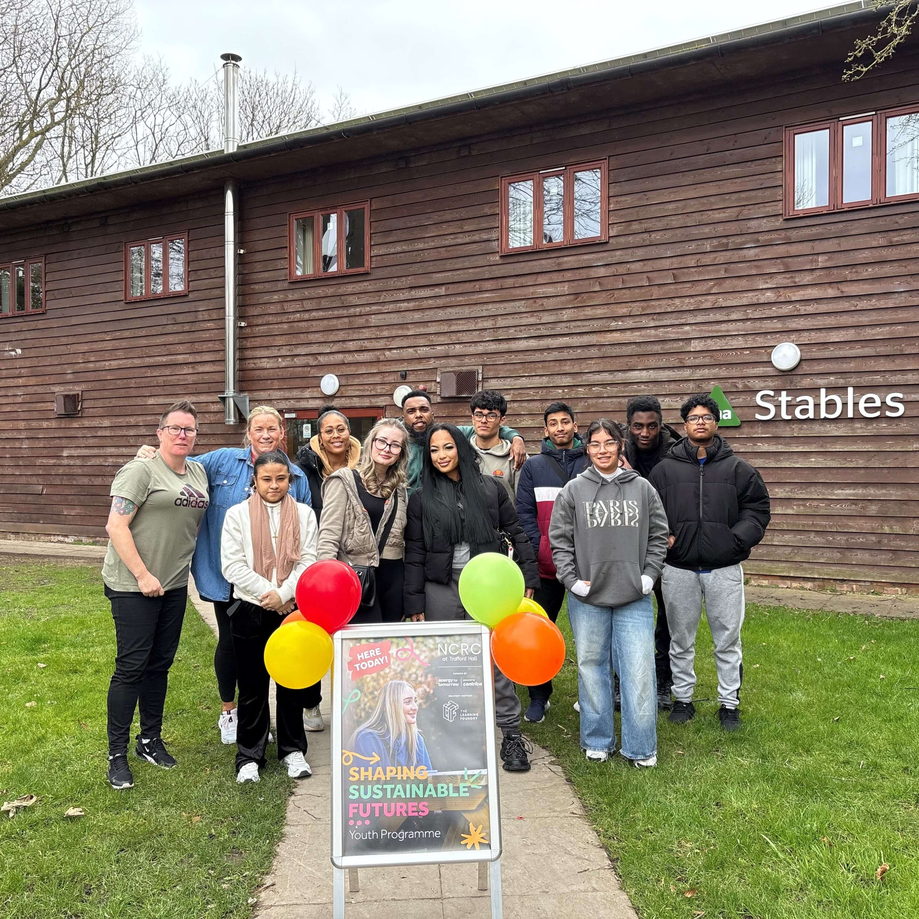 A group of young people standing in front of a building