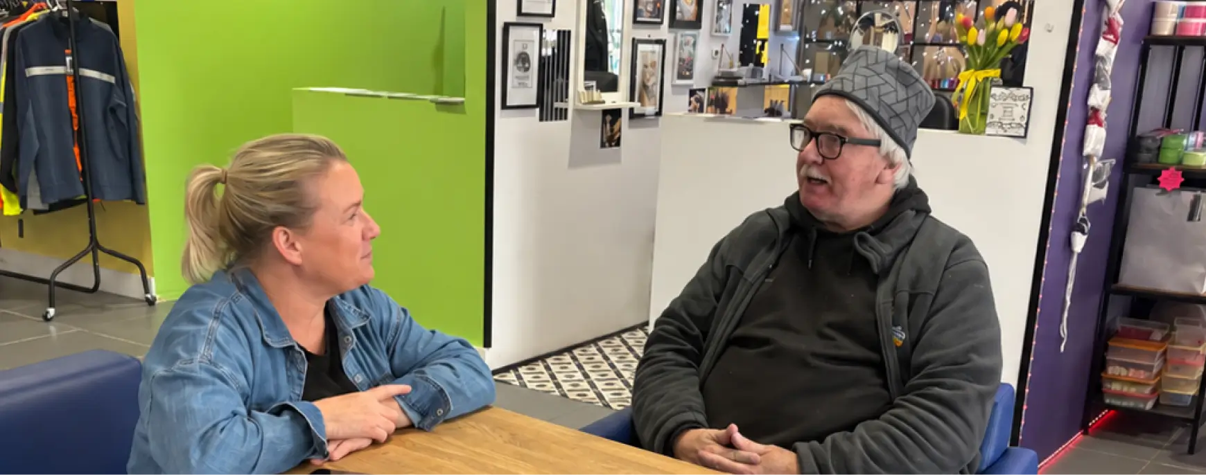 An image of a man and a woman sitting at a table having a conversation